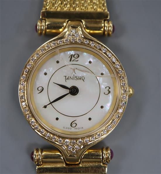 A ladys 18k wristwatch by Tanishq, India with diamond set bezel, on articulated bracelet (crystal a.f.)